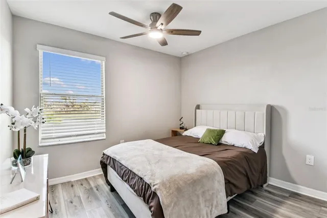 a bedroom with a bed and a window