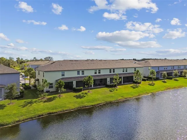 an aerial view of residential houses with outdoor space and swimming pool