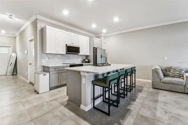 a kitchen with cabinets and chairs