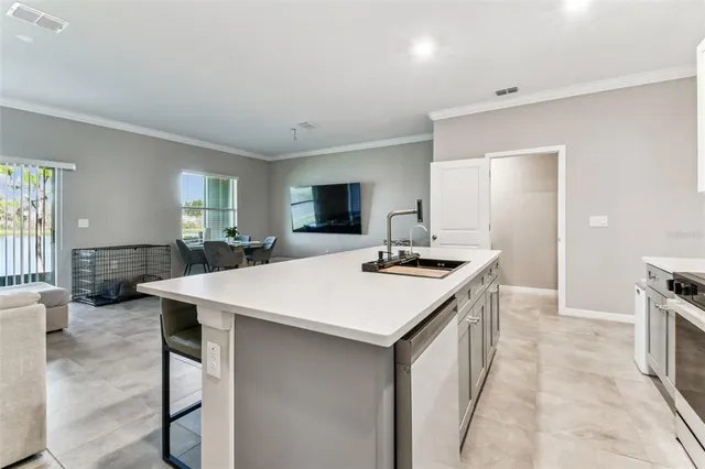 a kitchen with a stove a sink and a refrigerator