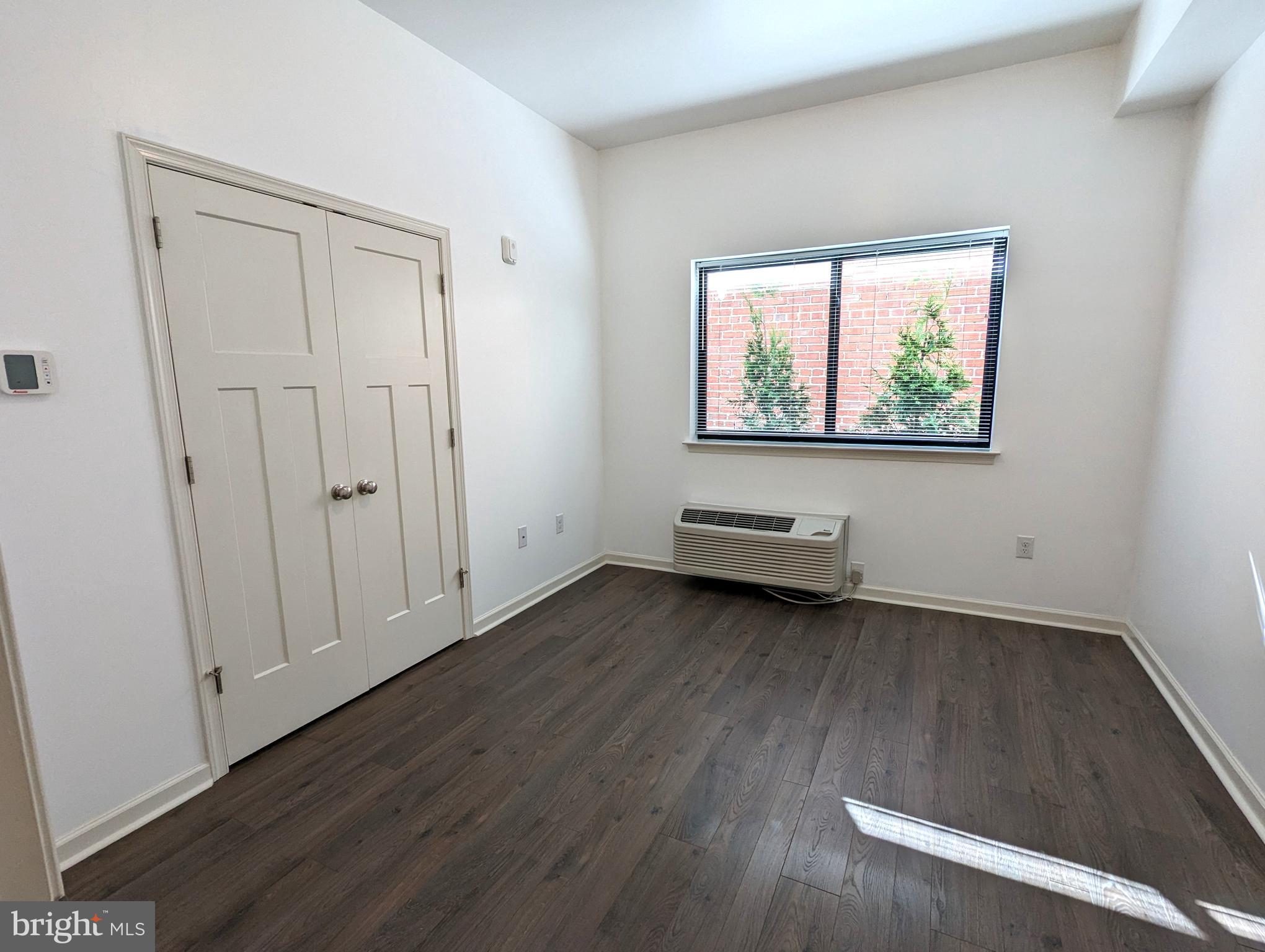5420 Ridge Avenue, Unit 104 Philadelphia, PA 19128 - Photo 5 of 7 a view of a livingroom with wooden floor and window