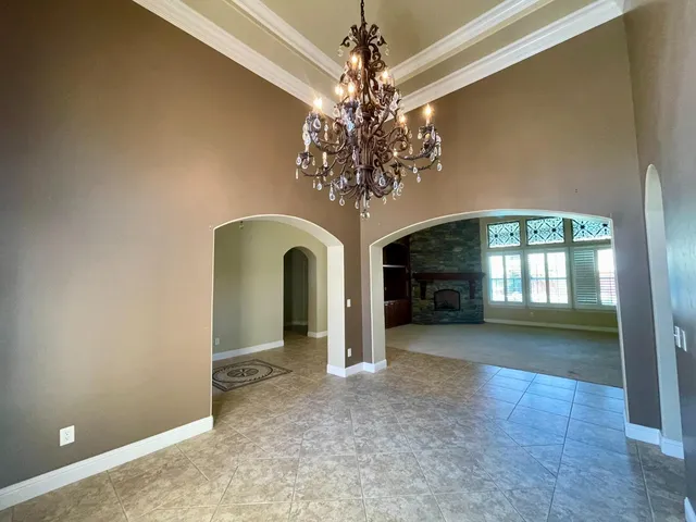 a kitchen with stainless steel appliances granite countertop a stove a sink dishwasher and a refrigerator with wooden cabinets