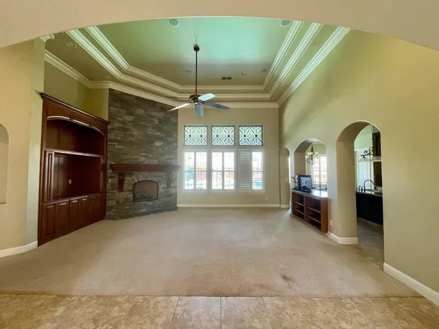 a kitchen with granite countertop wooden cabinets stainless steel appliances and a counter space