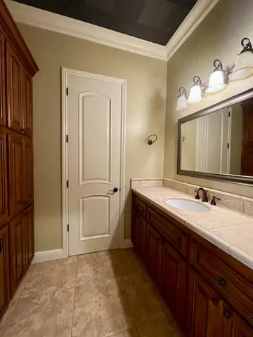 a bathroom with a sink a vanity and a mirror