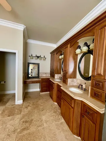 a view of a yard with plants and a barbeque