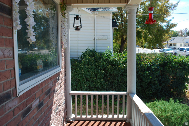 116 North 3rd Street Tooele, UT 84074 - Photo 4 of 45 Brick exterior with a prominent window, covered porch featuring a round column, and railing