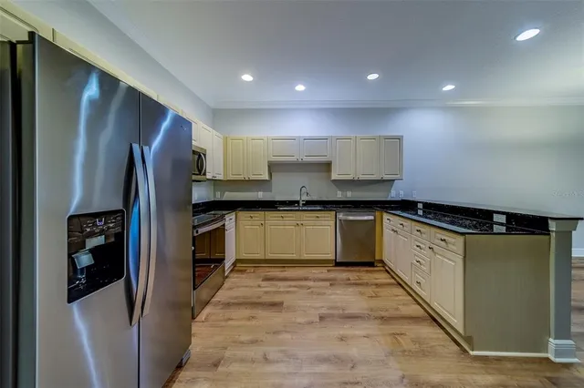 a kitchen with a refrigerator stove and white cabinets