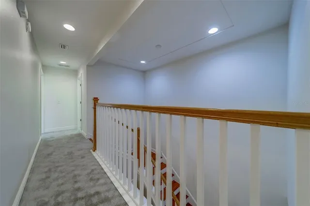 en empty room with windows and ceiling fan