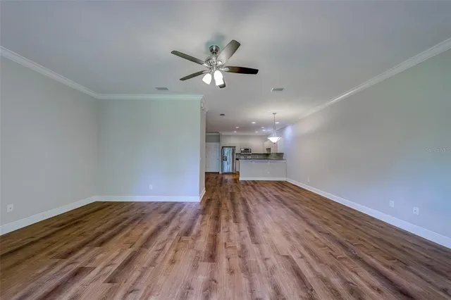 a view of livingroom with hardwood floor and kitchen view