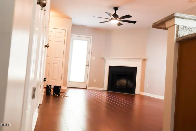 a view of a livingroom with a fireplace and wooden floor