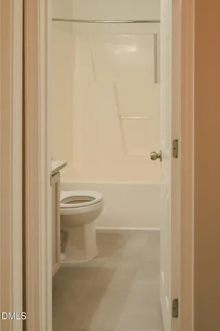 a bathroom with a shower and a toilet