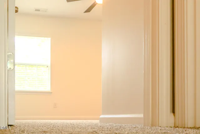 a view of a small space with wooden floor and a window