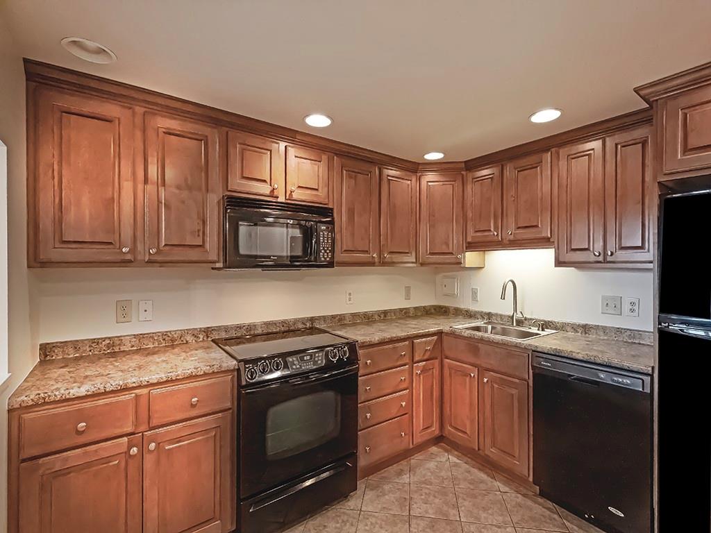 900 Washington Road, Unit 512 Pittsburgh, PA 15228 - Photo 14 of 29 a kitchen with a sink stove top oven and cabinets