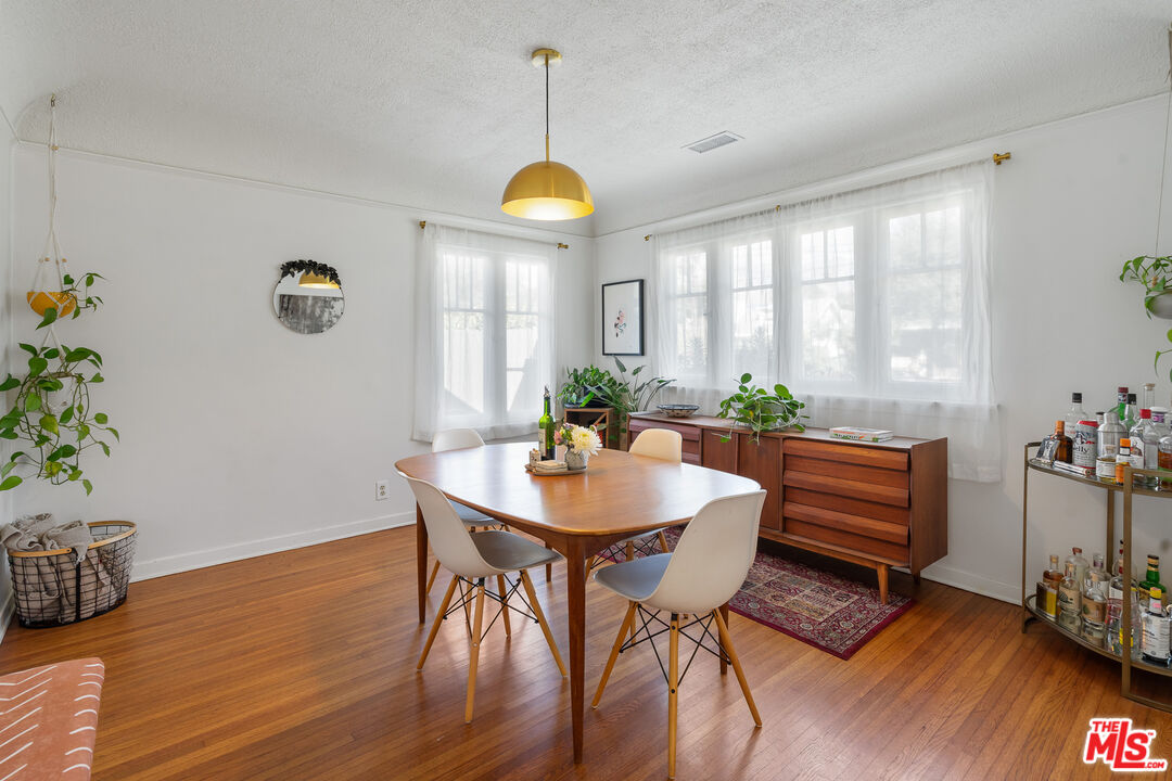 1955 Garfield Avenue Pasadena, CA 91104 - Photo 12 of 55 a view of a dining room with furniture and wooden floor