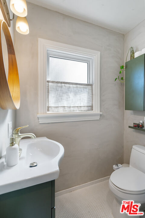 1955 Garfield Avenue Pasadena, CA 91104 - Photo 27 of 55 a bathroom with a toilet sink and mirror
