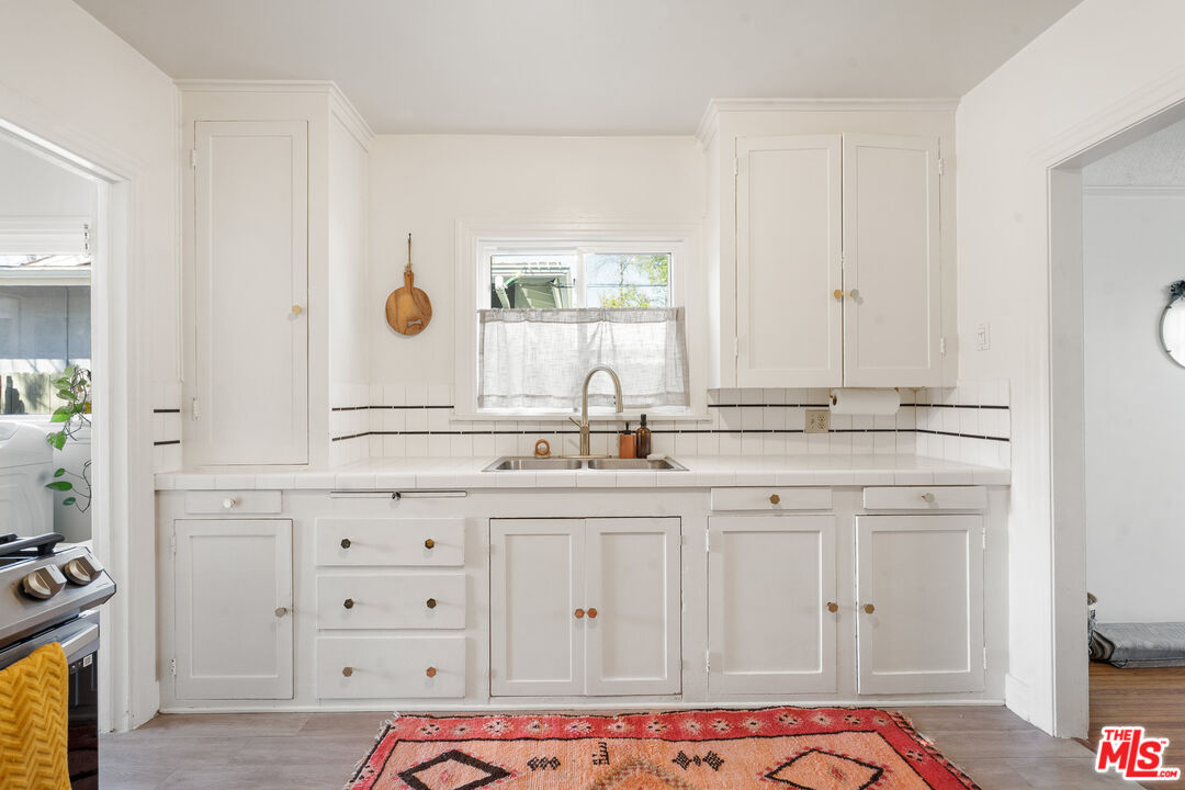 1955 Garfield Avenue Pasadena, CA 91104 - Photo 35 of 55 a bathroom with cabinets appliances and a sink