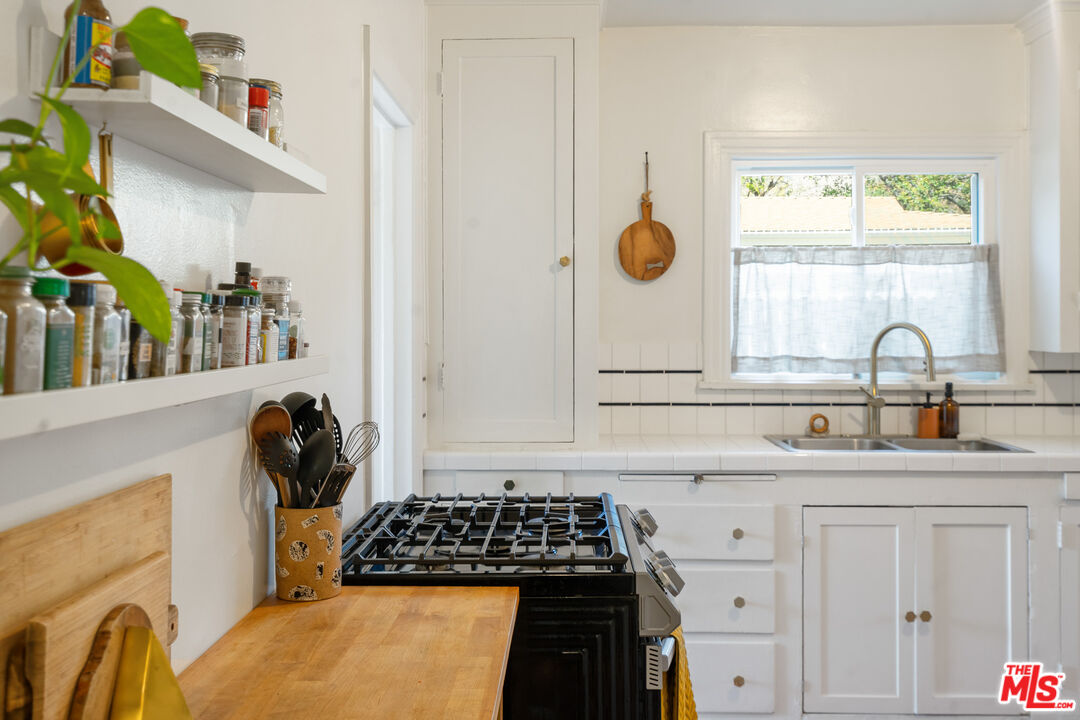 1955 Garfield Avenue Pasadena, CA 91104 - Photo 36 of 55 a kitchen with a sink and a stove top oven