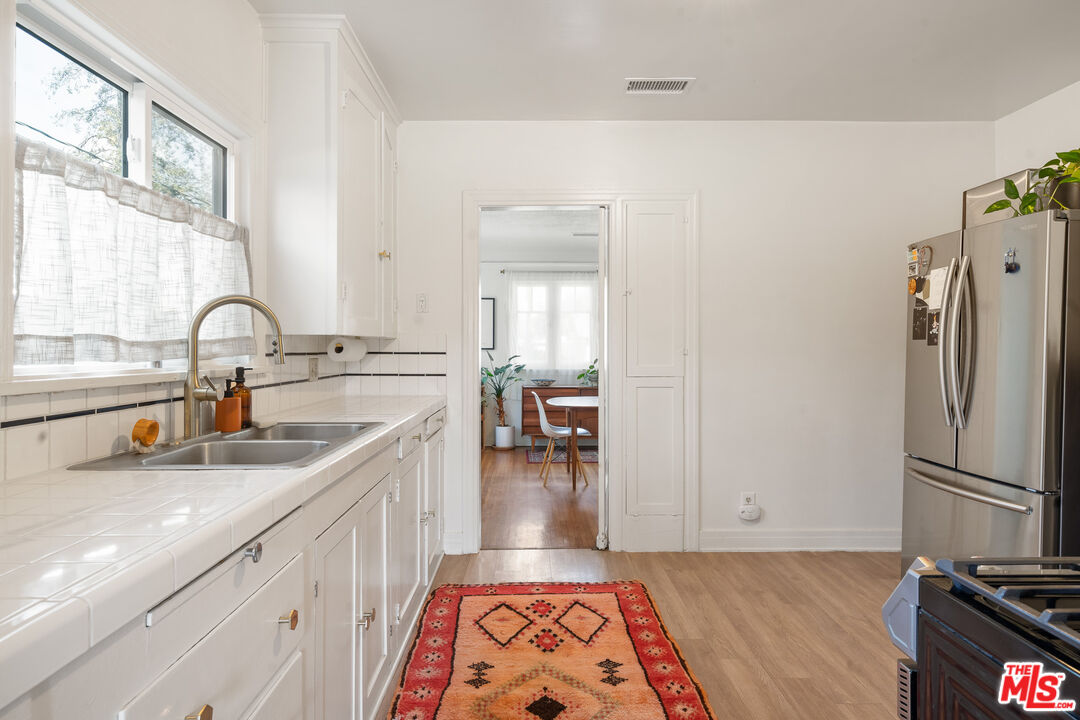 1955 Garfield Avenue Pasadena, CA 91104 - Photo 37 of 55 a kitchen with a refrigerator and a sink