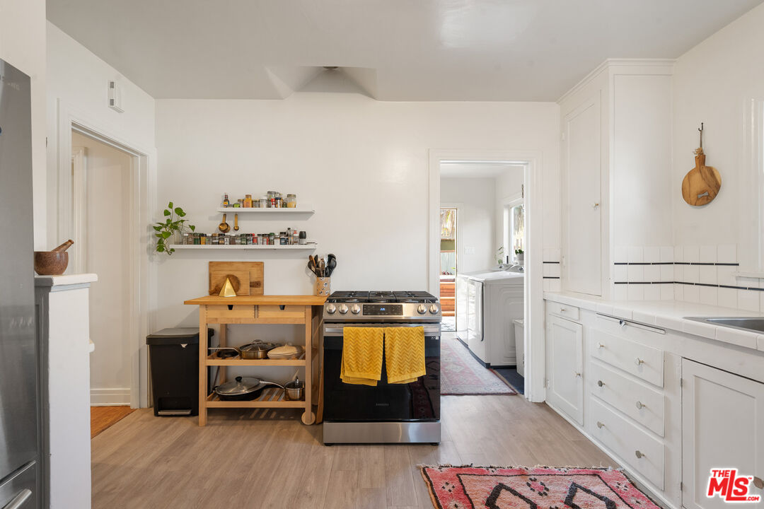 1955 Garfield Avenue Pasadena, CA 91104 - Photo 38 of 55 a room with a baby crib furniture and wooden floor