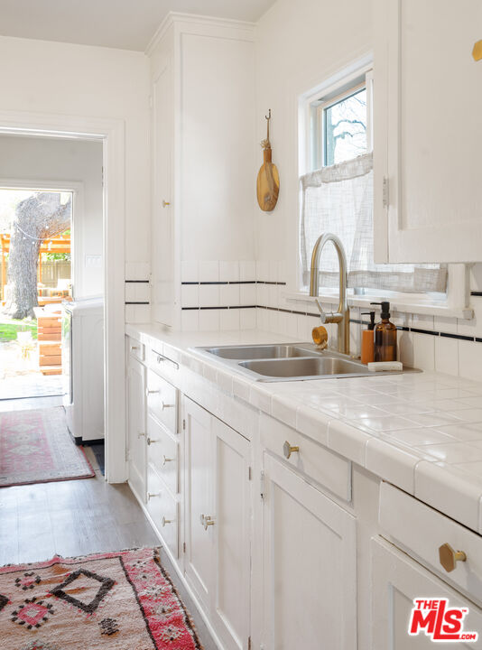 1955 Garfield Avenue Pasadena, CA 91104 - Photo 39 of 55 a bathroom with a sink and a mirror