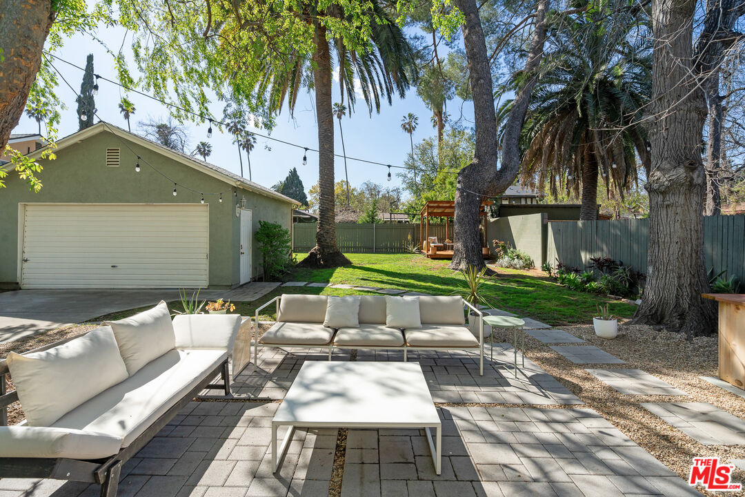1955 Garfield Avenue Pasadena, CA 91104 - Photo 44 of 55 a view of a patio with table and chairs potted plants and large tree