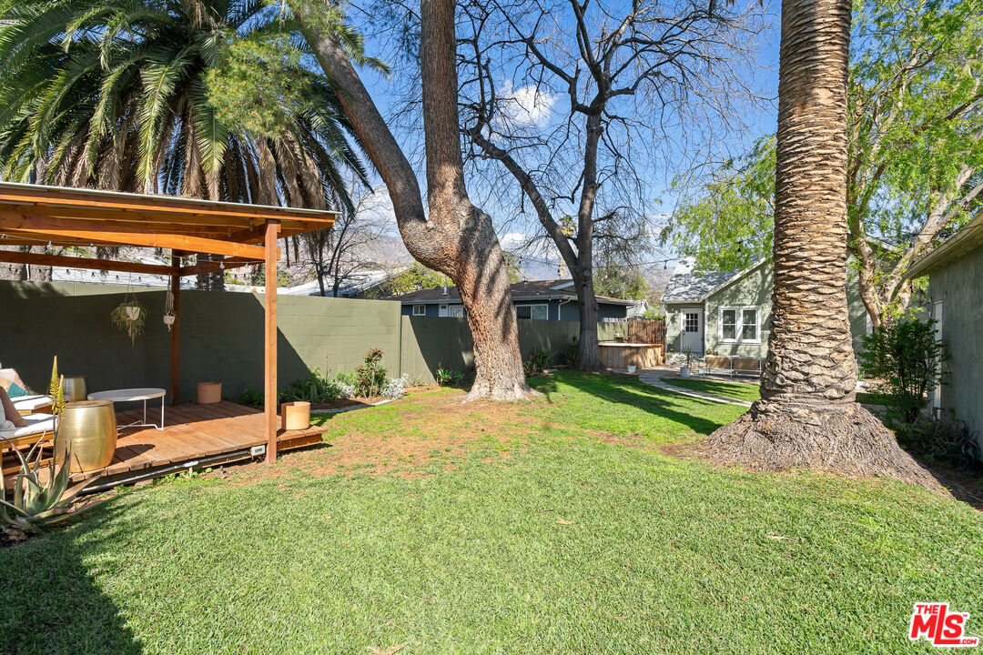 1955 Garfield Avenue Pasadena, CA 91104 - Photo 46 of 55 a view of backyard with a table and chairs and a barbeque