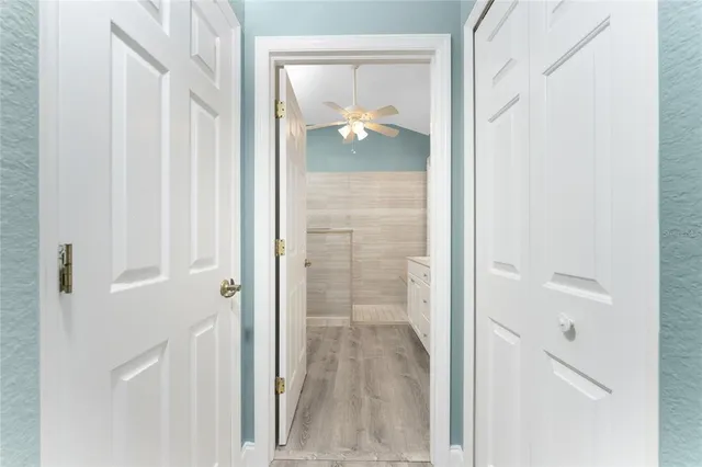 a view of a swimming pool with a chair and table in the patio
