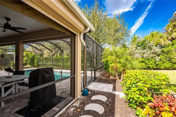 a view of a house with backyard sitting area and garden