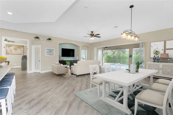 a living room with furniture and kitchen view
