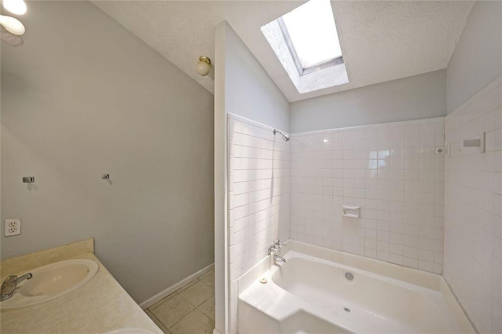 3087 Drexel Lane Rex, GA 30273 - Photo 14 of 22 a bathroom with a tub shower and sink