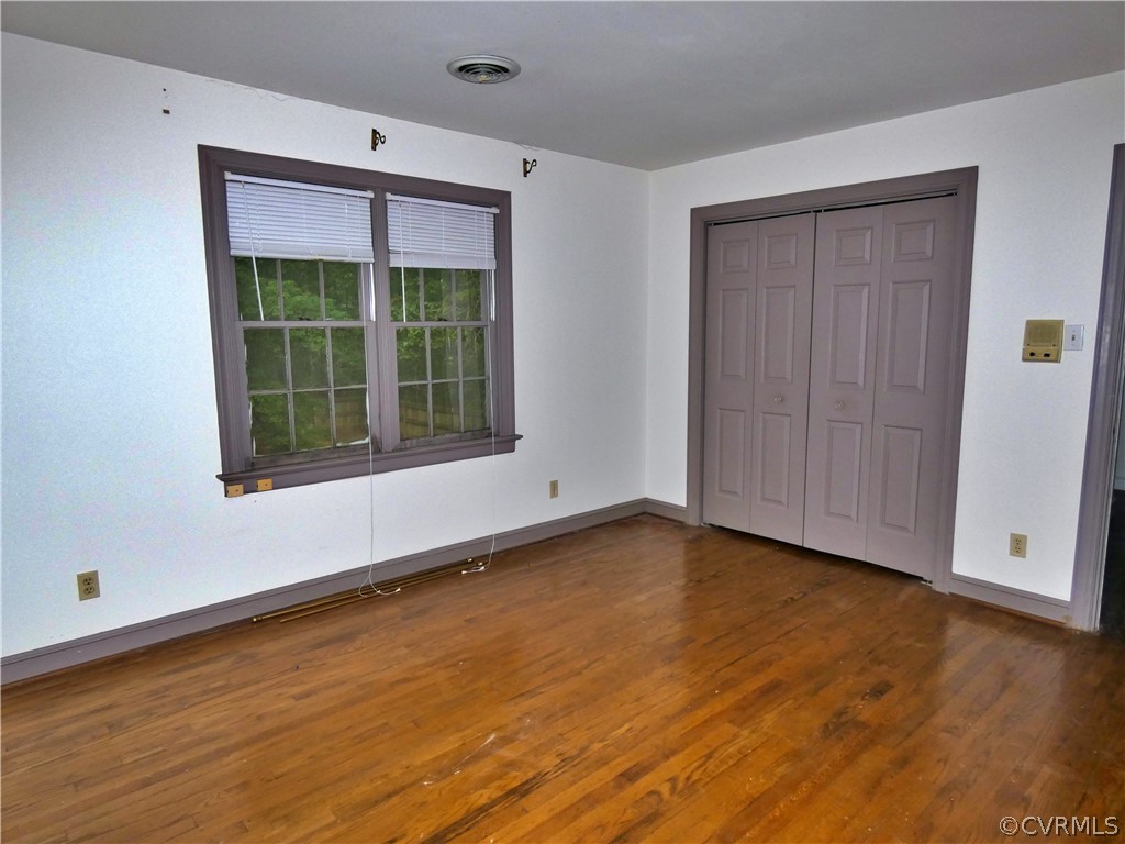 14011 Chepstow Road Midlothian, VA 23113 - Photo 25 of 49 a view of an empty room with wooden floor and a window