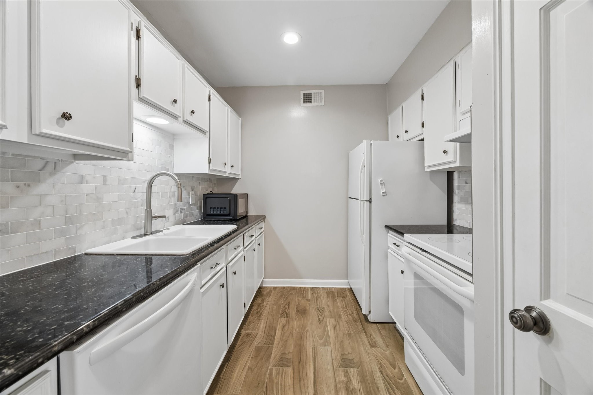 2230 South Piney Point Road, Unit 103 Houston, TX 77063 - Photo 10 of 28 Lovely galley kitchen with granite countertops. Microwave included!