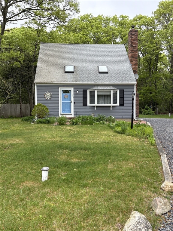 92 Santuit Pond Road Mashpee, MA 02649 - Photo 1 of 23 a aerial view of a house next to a yard with large trees
