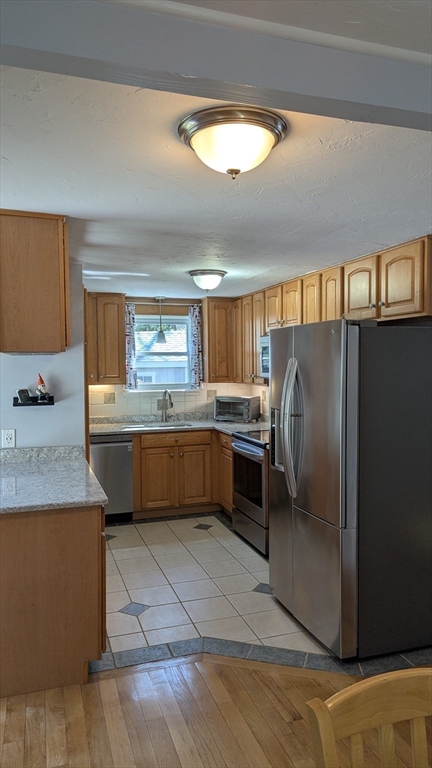 92 Santuit Pond Road Mashpee, MA 02649 - Photo 14 of 23 a kitchen with a refrigerator sink and cabinets