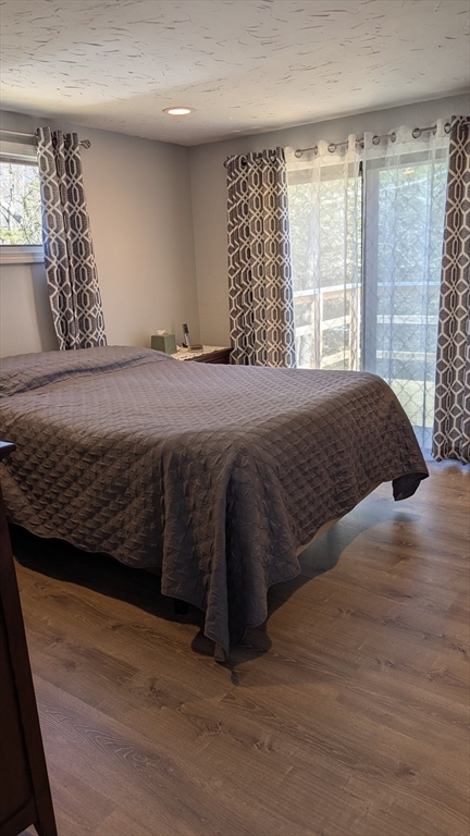 92 Santuit Pond Road Mashpee, MA 02649 - Photo 16 of 23 a bed sitting in a bedroom next to a window