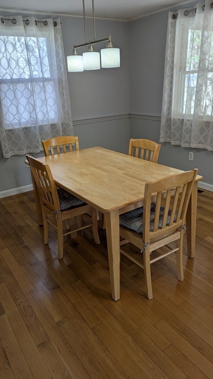 92 Santuit Pond Road Mashpee, MA 02649 - Photo 23 of 23 a dining room with furniture a chandelier and wooden floor