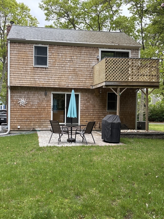 92 Santuit Pond Road Mashpee, MA 02649 - Photo 3 of 23 a view of a house with a backyard