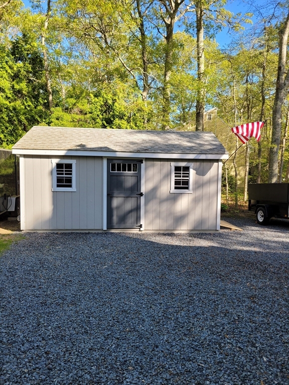 92 Santuit Pond Road Mashpee, MA 02649 - Photo 5 of 23 a view of a house with a backyard
