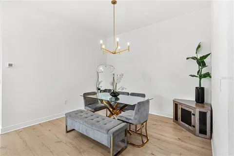 a view of a hallway with wooden floor and front door
