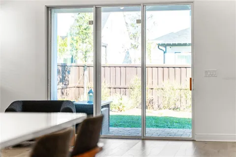 a view of a hallway with wooden floor and stairs