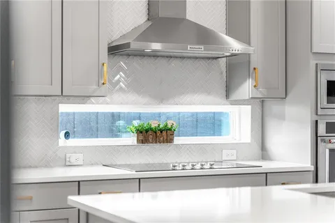 a kitchen with stainless steel appliances a table chairs window and kitchen view