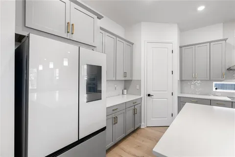 a kitchen with stainless steel appliances kitchen island a refrigerator a stove a sink and a oven