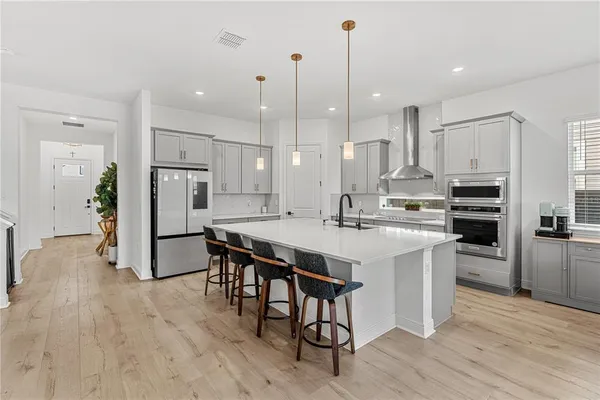 a kitchen with kitchen island a sink stainless steel appliances and cabinets