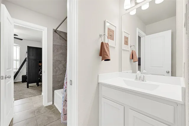a en suite bathroom with a sink and a mirror