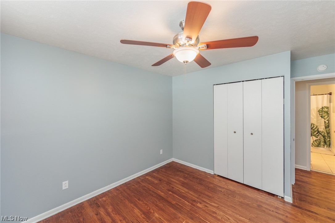 4260 Ridgeview Road Cleveland, OH 44144 - Photo 22 of 34 Unfurnished bedroom with a closet, ceiling fan, and dark hardwood / wood-style floors