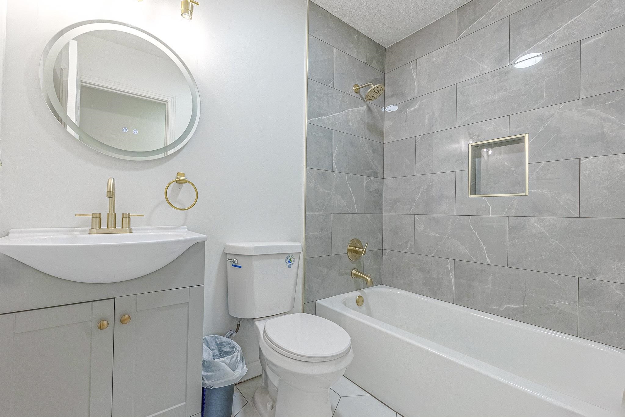 1165 Clift Road Bolivar, TN 38008 - Photo 4 of 26 Bathroom with bathtub / shower combination, vanity, and tile patterned floors