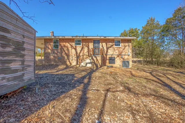 a view of a yard with wooden fence