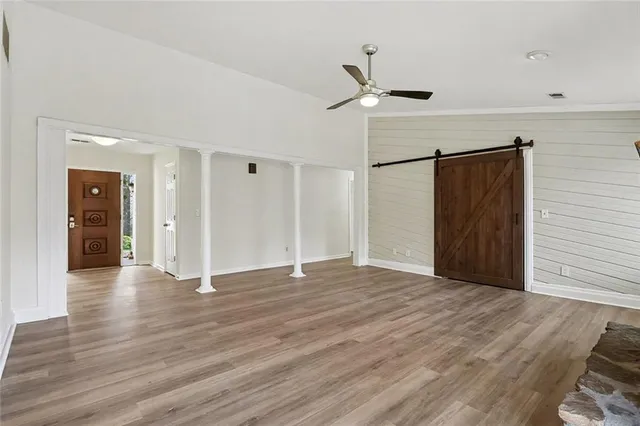 a view of an empty room with wooden floor