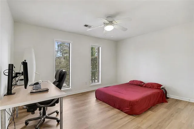 a bedroom with a bed and a desk
