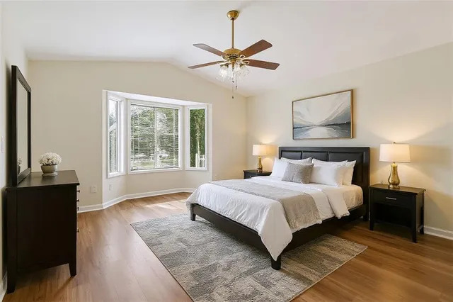 a bedroom with a bed and wooden floor